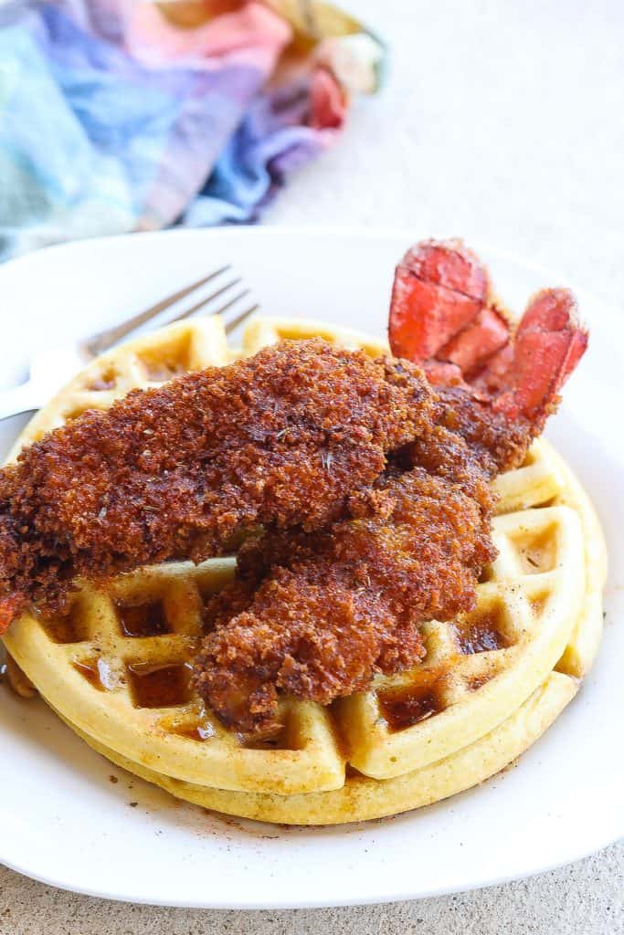 fried lobster tails on top of waffles