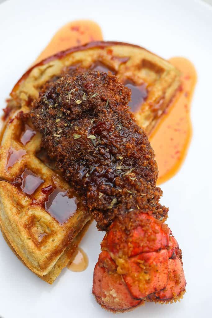 fried lobster tails on top of waffles