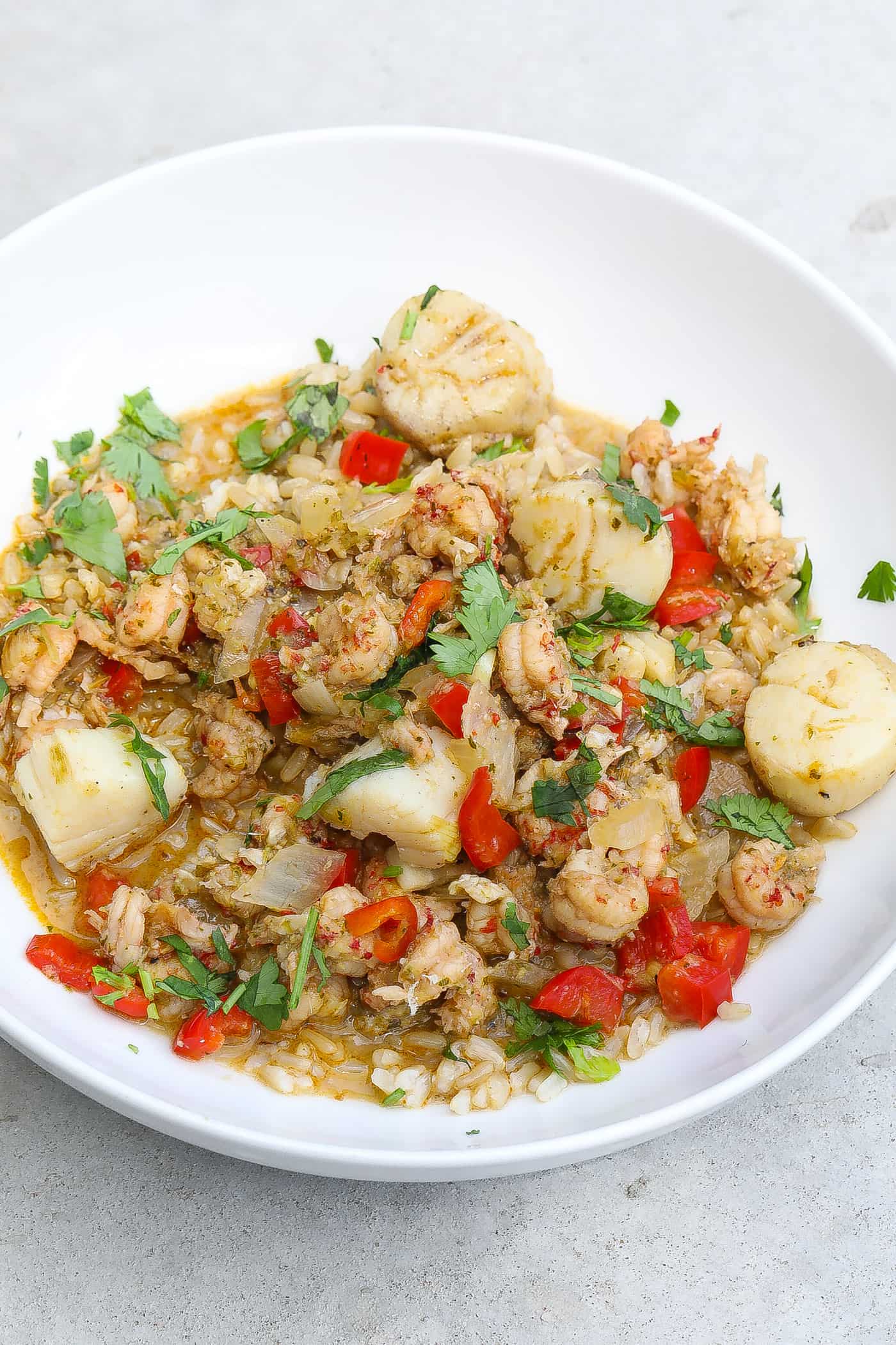 seafood stew in white bowl with rice