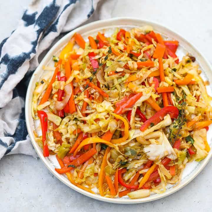 colorful jamaican steamed cabbage in white pan