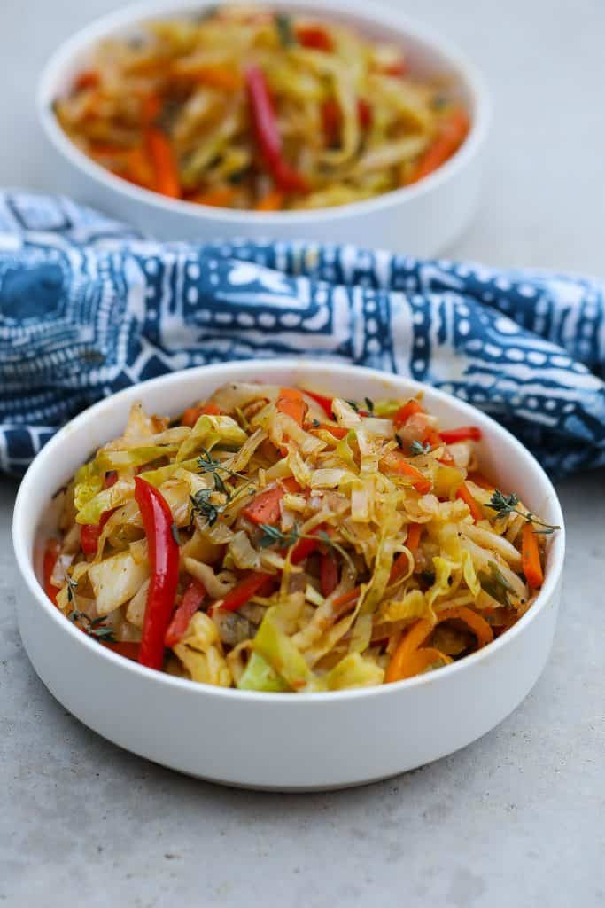 colorful jamaican steamed cabbage in 2 white bowls