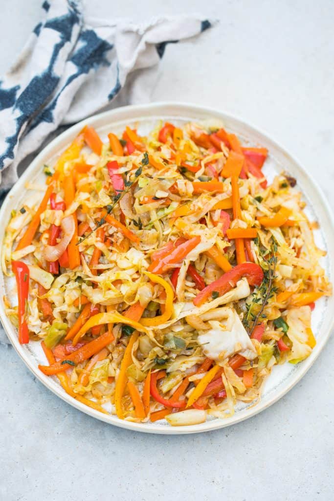 colorful jamaican steamed cabbage in white pan