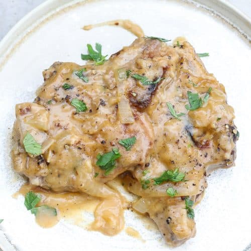 smothered pork chops on a plate