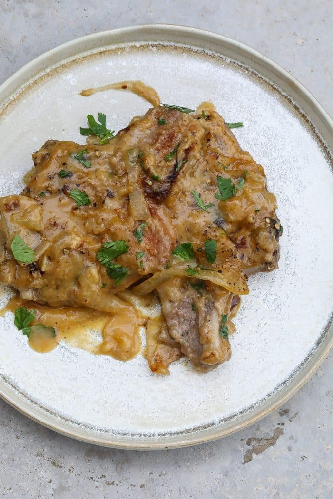 smothered pork chops on a plate