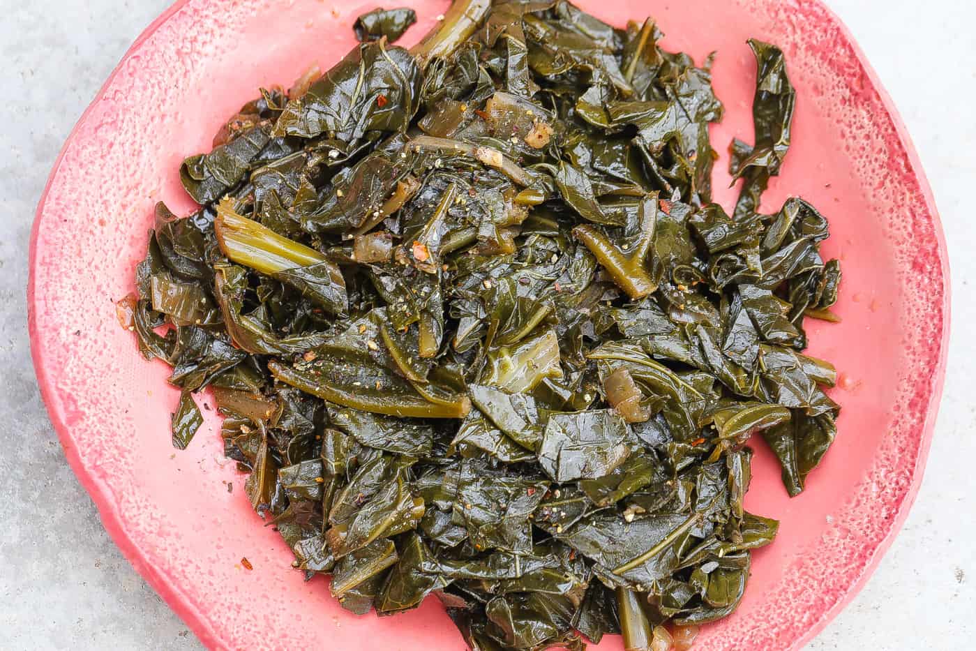 collard greens on a pink plate
