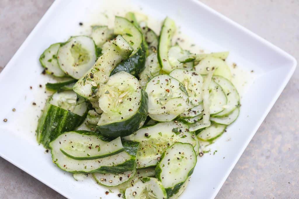 cucumber salad on a white plate