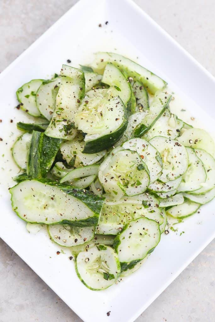 cucumber salad on a white plate