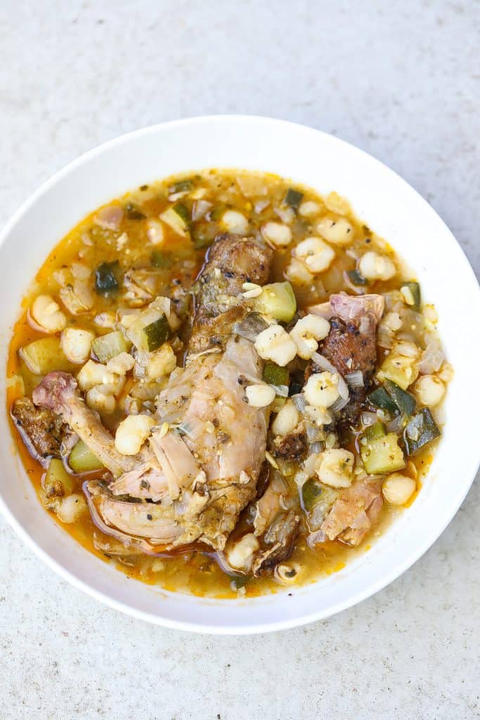 chicken pozole verde in a white bowl