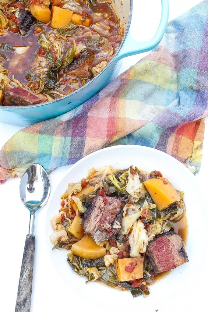 cabbage stew with brisket and rutabagas in white bowl