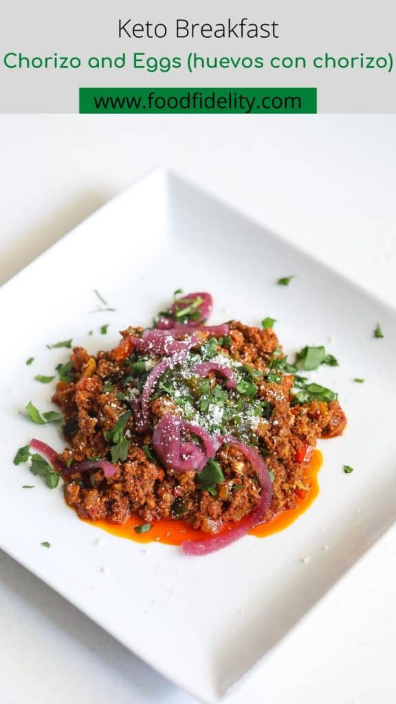 chorizo and eggs on a white plate