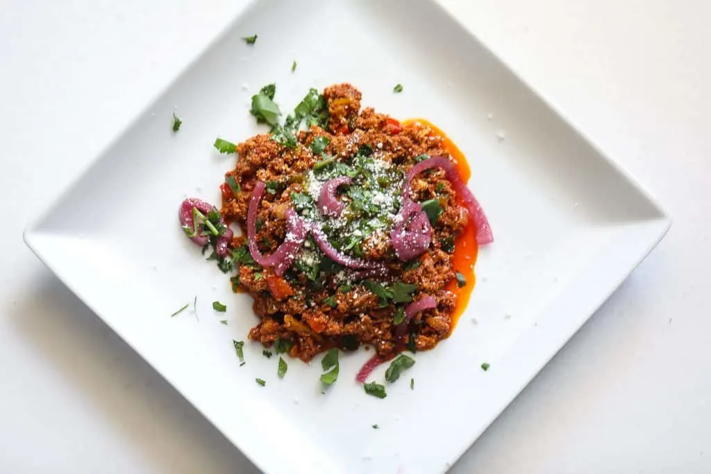 chorizo and eggs on a white plate