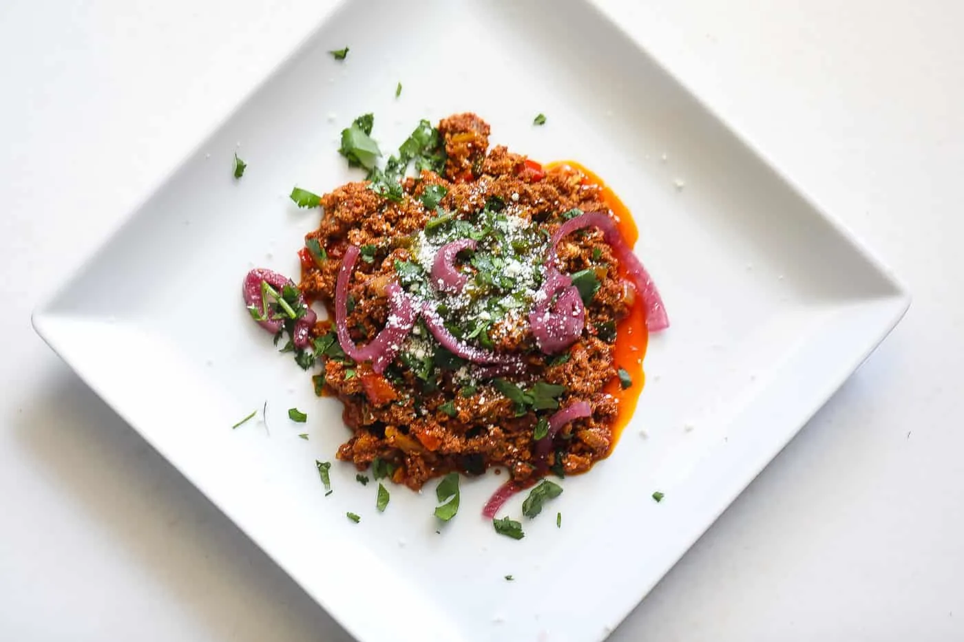 chorizo and eggs on a white plate