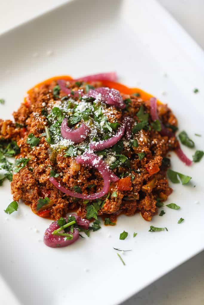 chorizo and eggs on a white plate