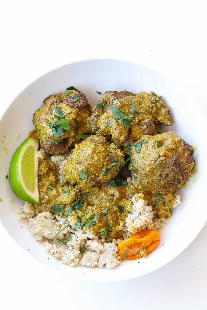 meatballs in bowl with rice topped with gravy