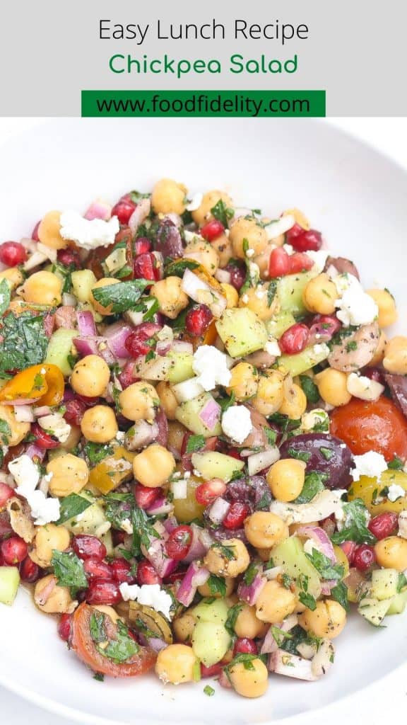 chickpea salad with pomegranate seeds in white bowl