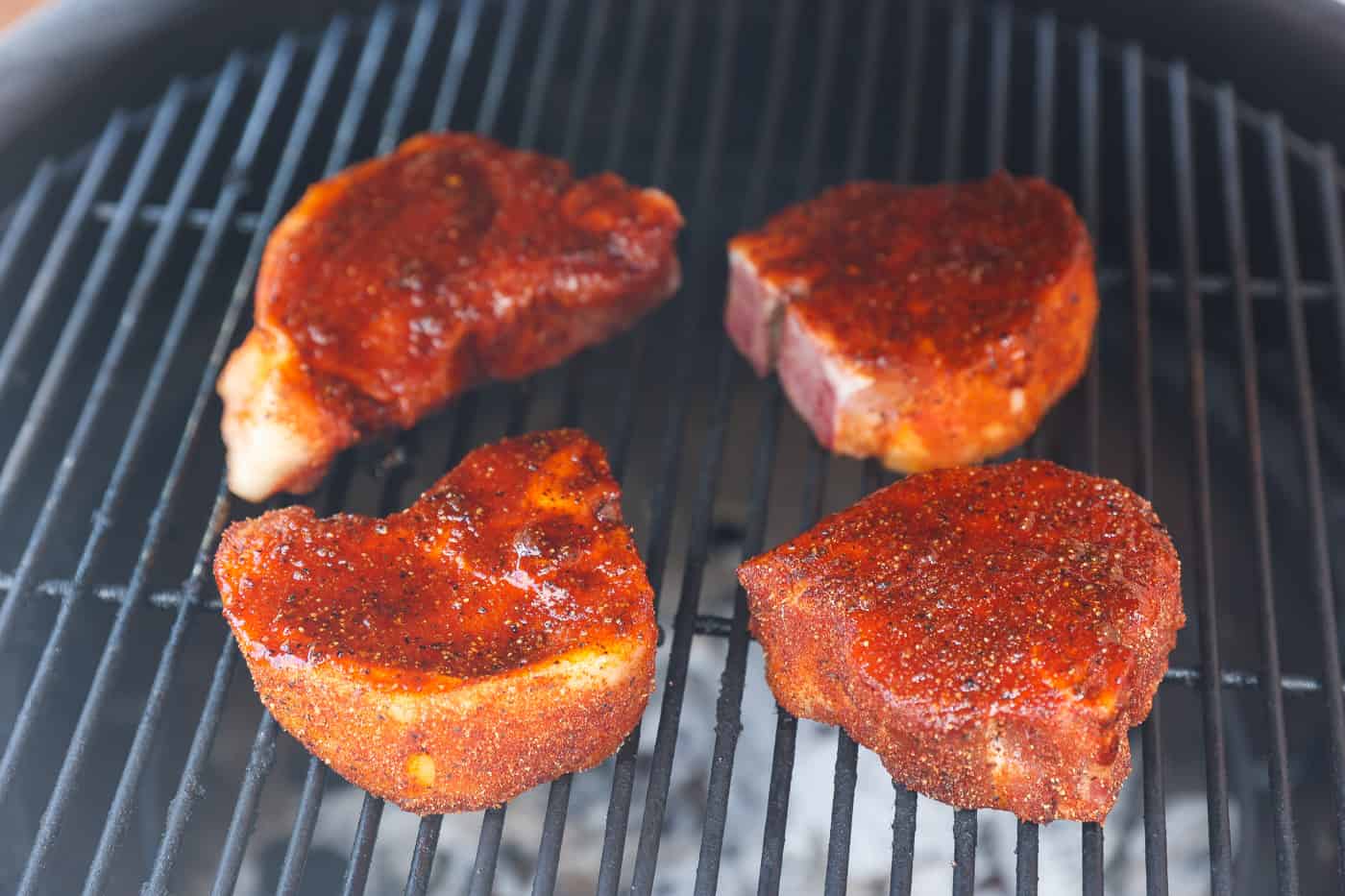 4 pork chops on the grill cooking