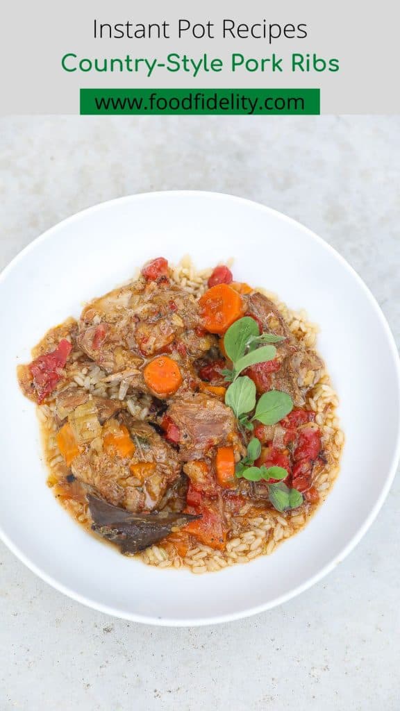 country-style pork ribs with rice topped with sauce and carrots