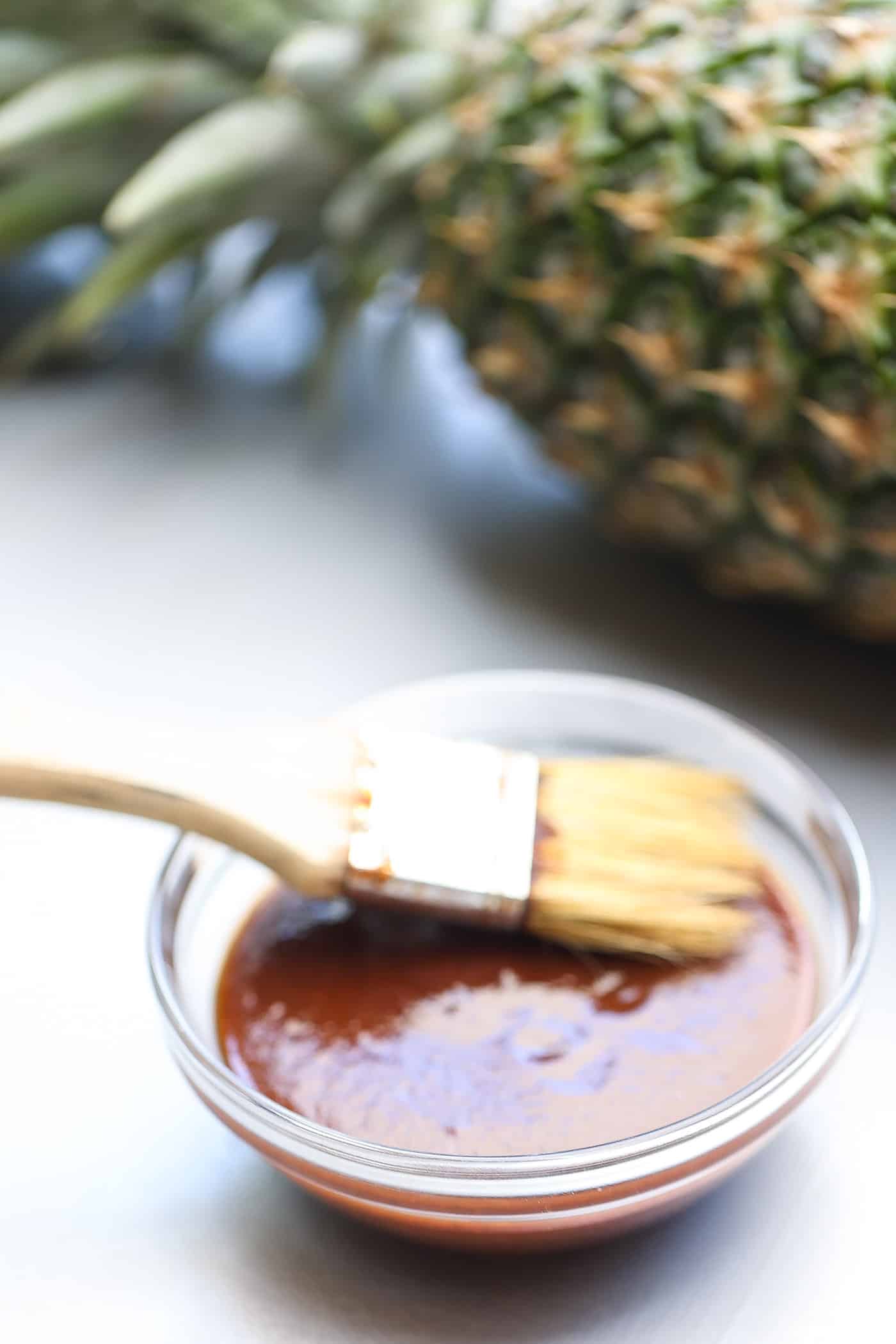 pineapple bbq sauce in a glass bowl with brush