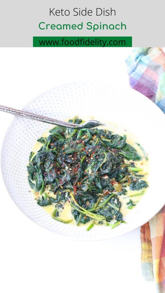 sauteed spinach in a white bowl with creamy sauce