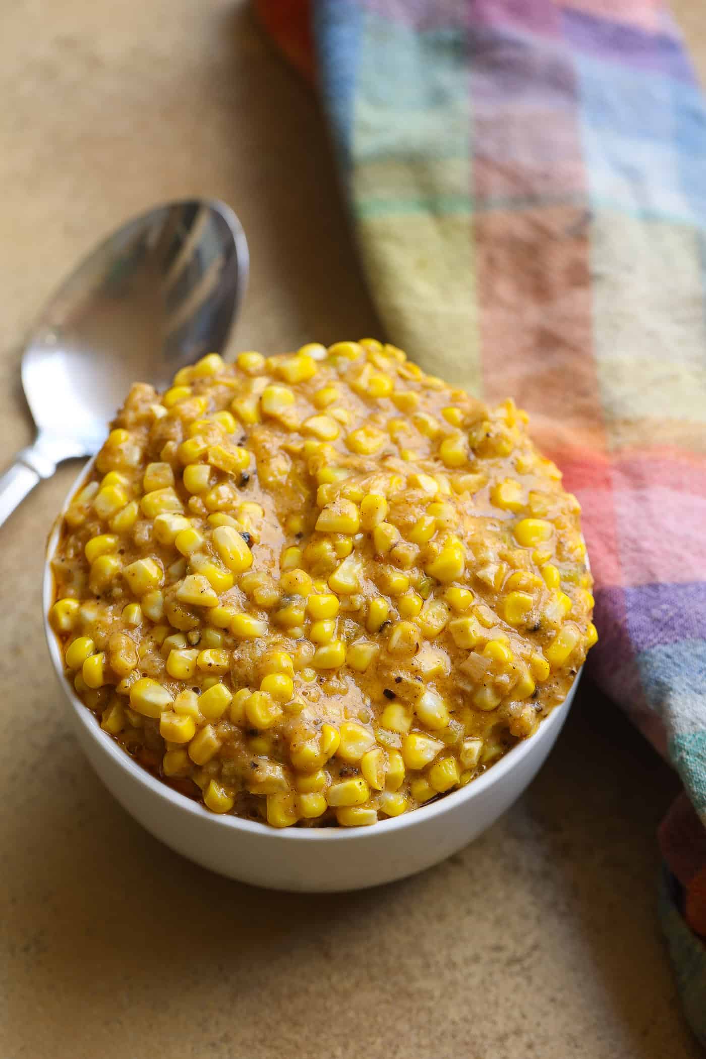 creamed corn kernels in a white bowl