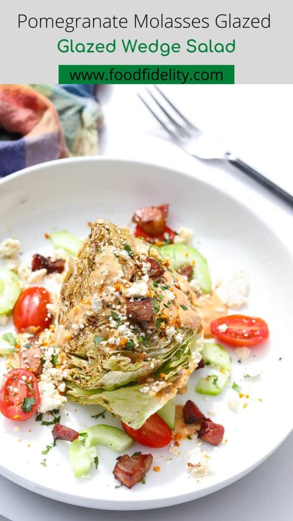 wedge salad on white plate with tomatoes and dressing