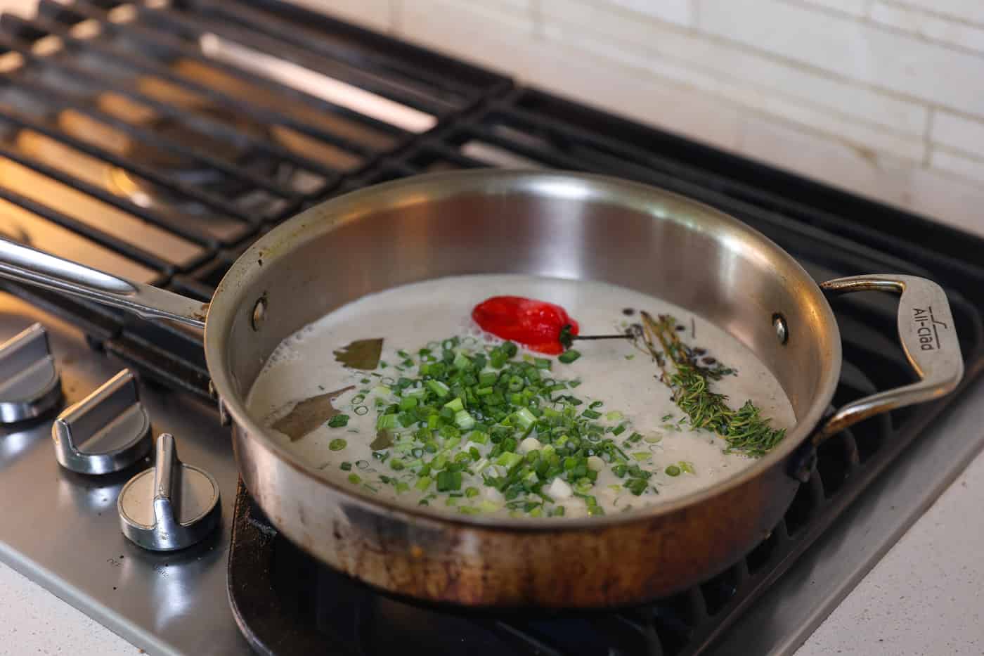 green onions and coconut milk in skillet