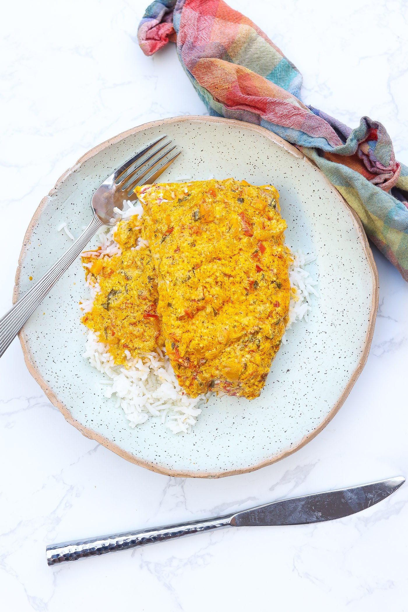 red snapper fish filet with yellow sauce and rice