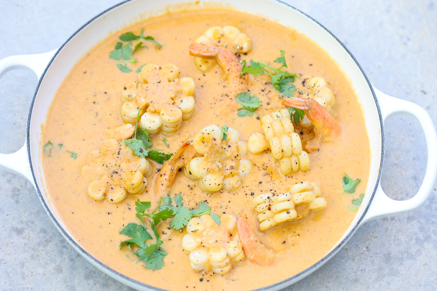 shrimp and corn chowder in a white pan