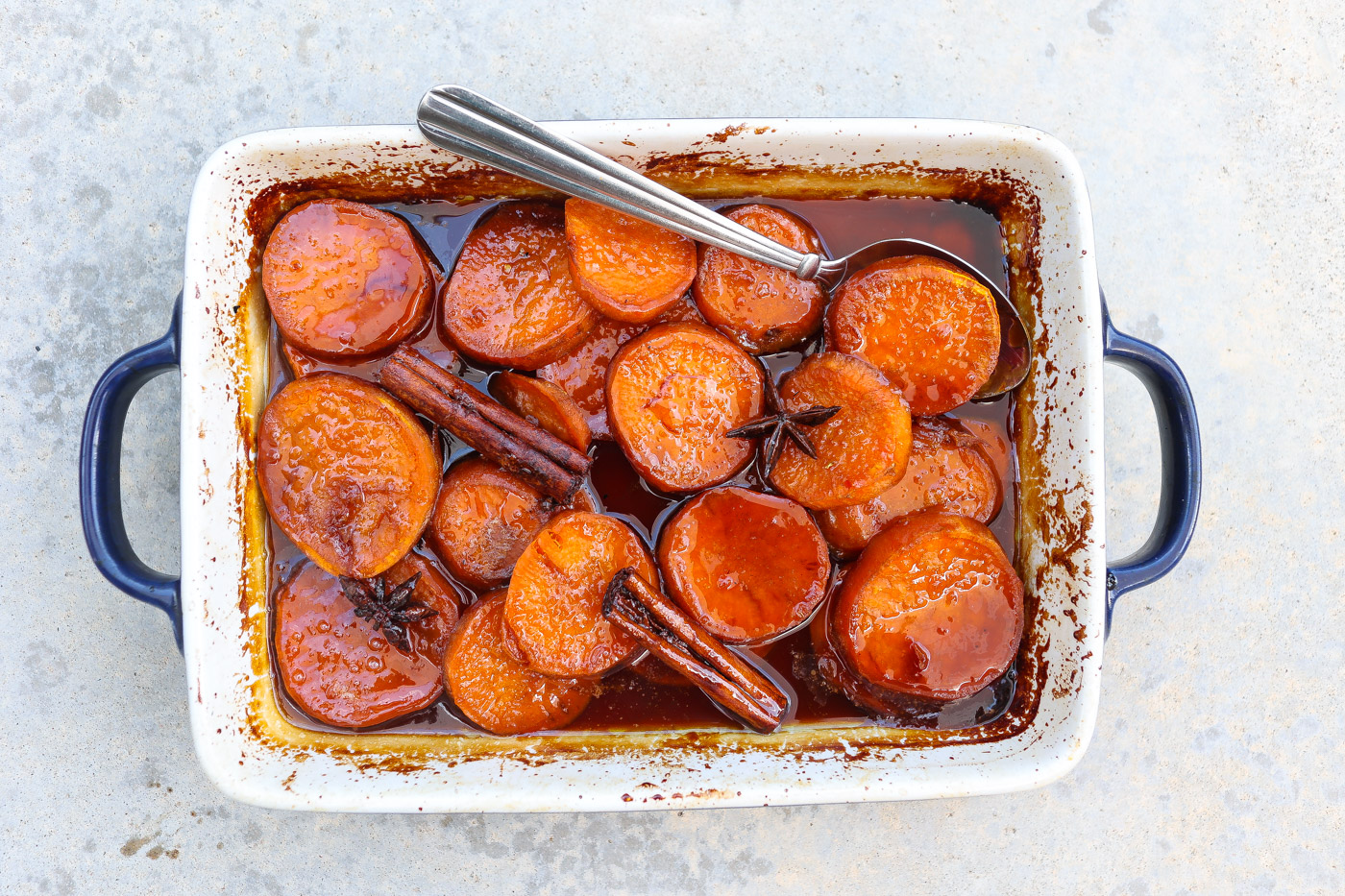 candied yams in a white baking dish