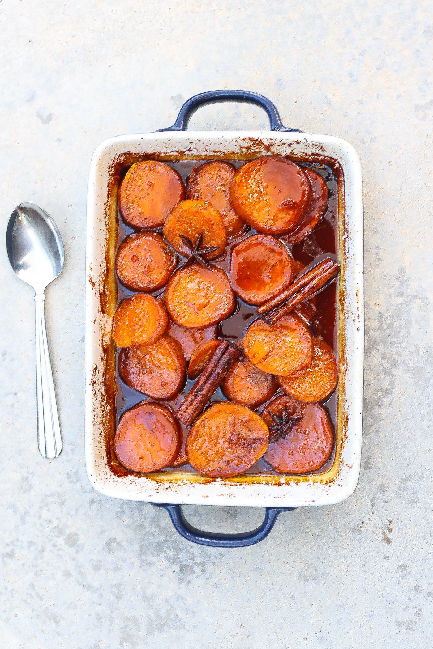 candied yams in a white baking dish