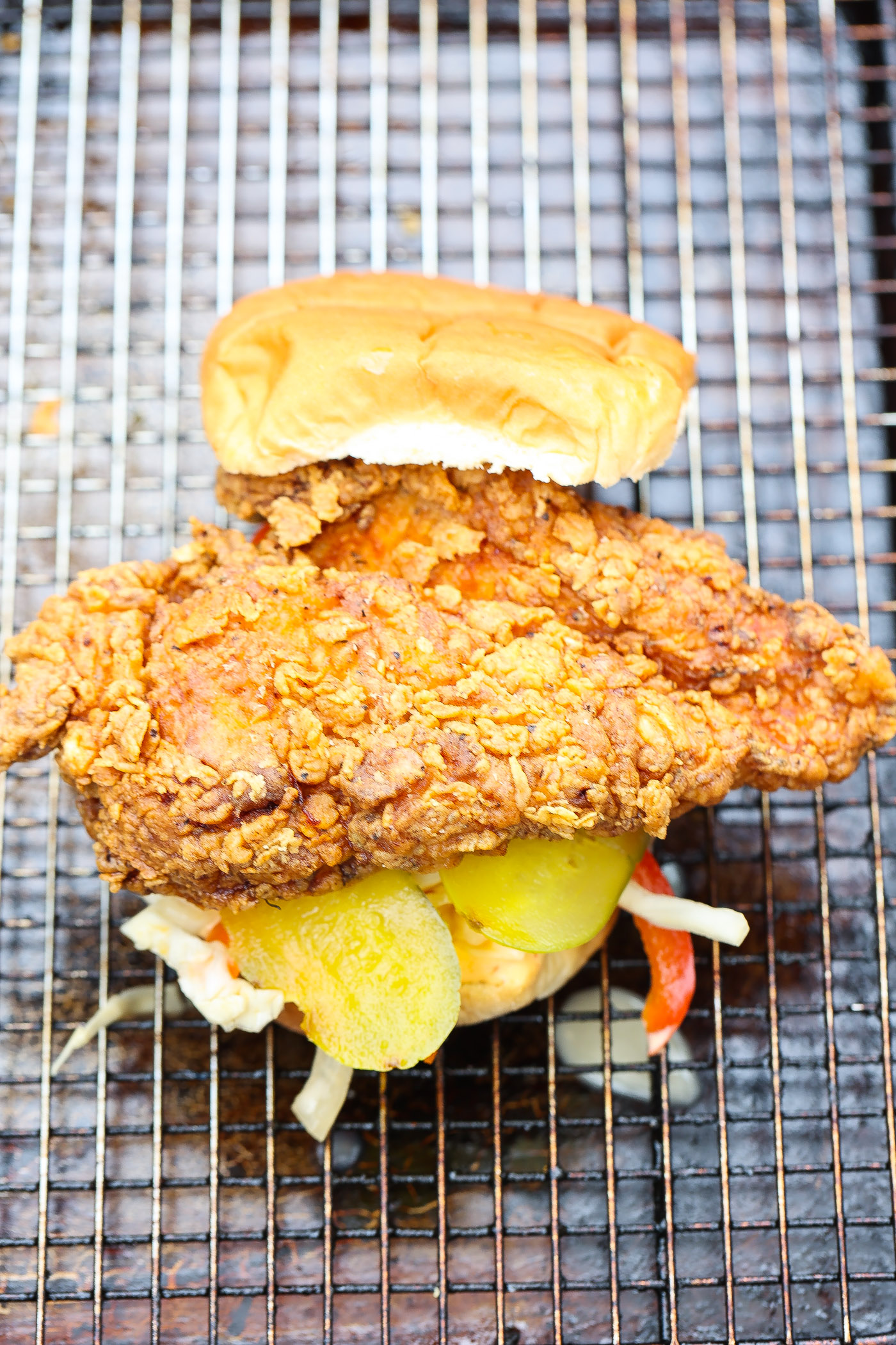 fried chicken sandwich on wire rack lined baking sheet