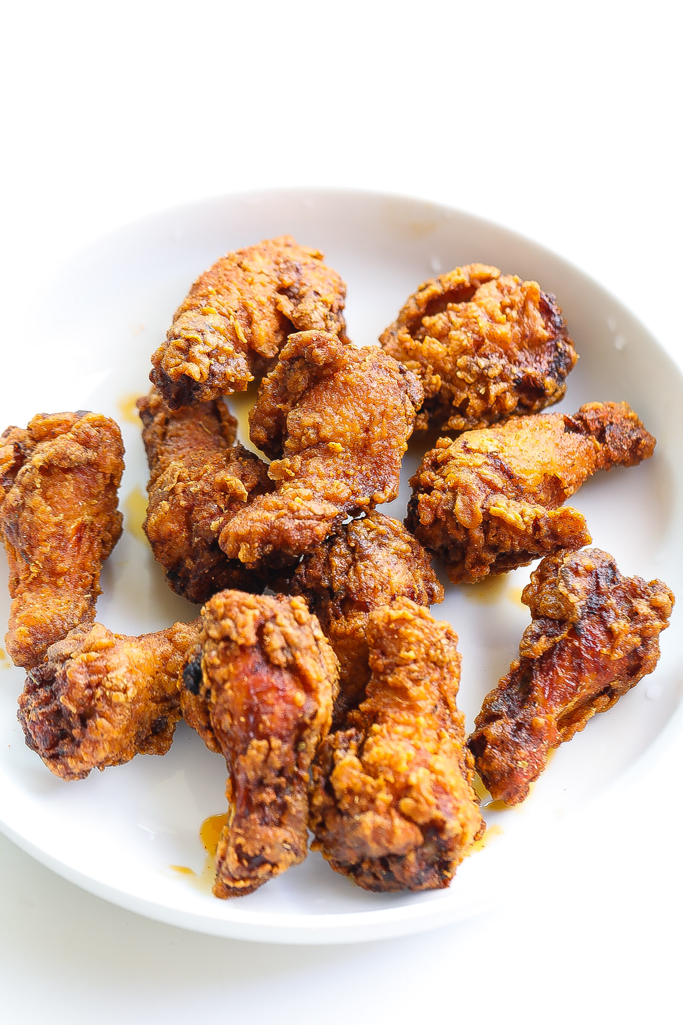 fried chciekn drumettes in a white bowl