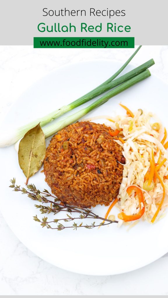 red rice on white plate with green onions and haitian pikliz
