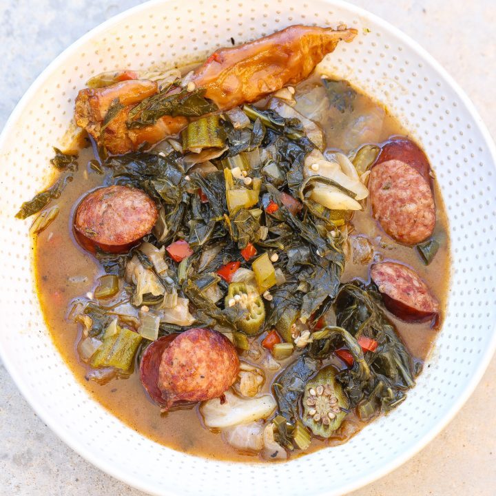 cooked gumbo z'herbes in a white bowl with spoon.