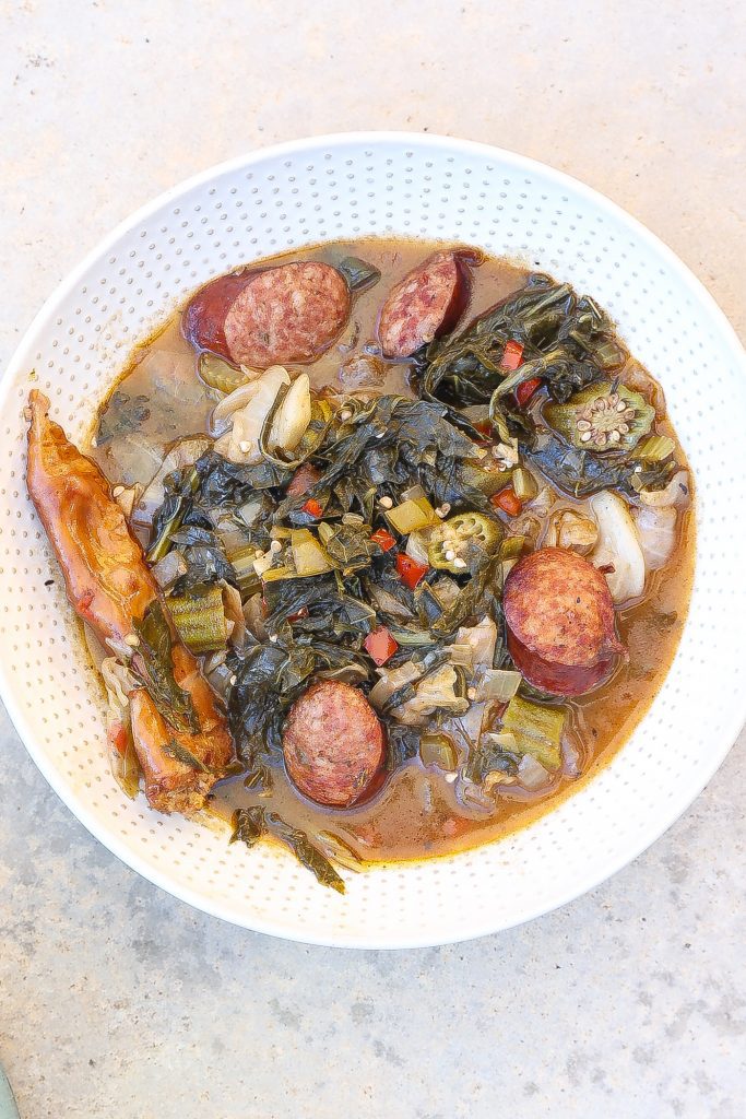 cooked gumbo z'herbes in a white bowl with spoon.