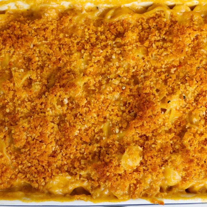 vegan mac and cheese with crunchy topping in a white baking dish