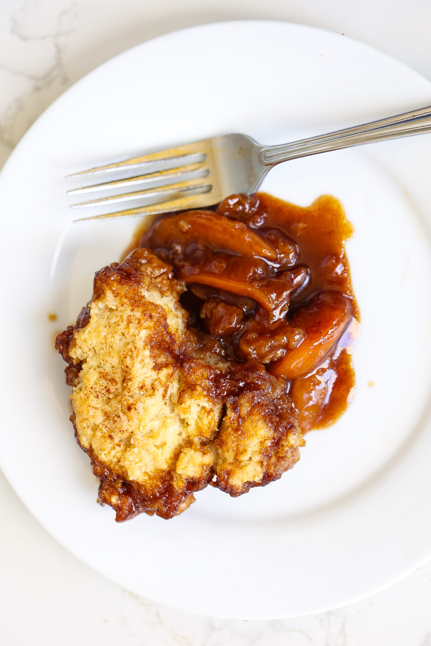 peach cobbler on a white plate