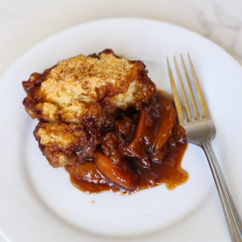 peach cobbler on a white plate
