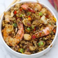 seafood fried rice with shrimp on a white plate