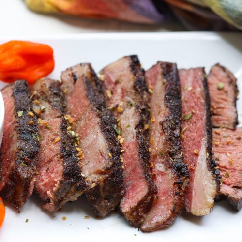 tender slices of sous vide chuck steak on white plate