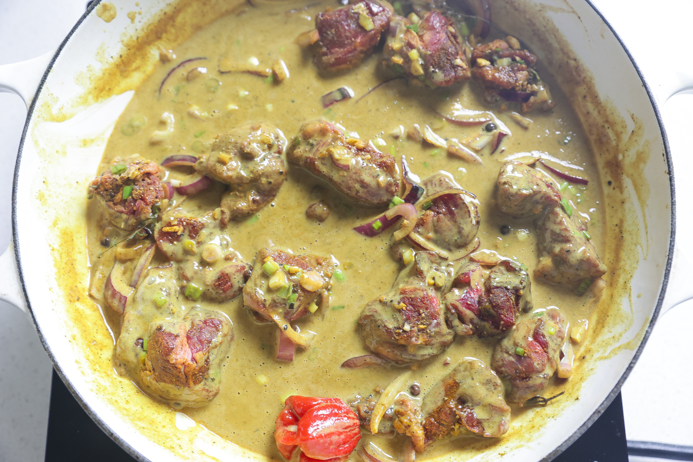 coconut beef curry cooking in pan