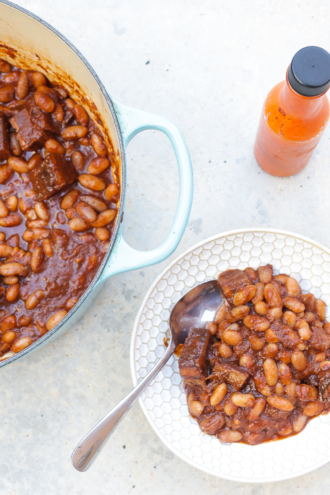 pork and beans in white bowl
