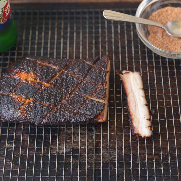 smoked pork belly on a grill grate