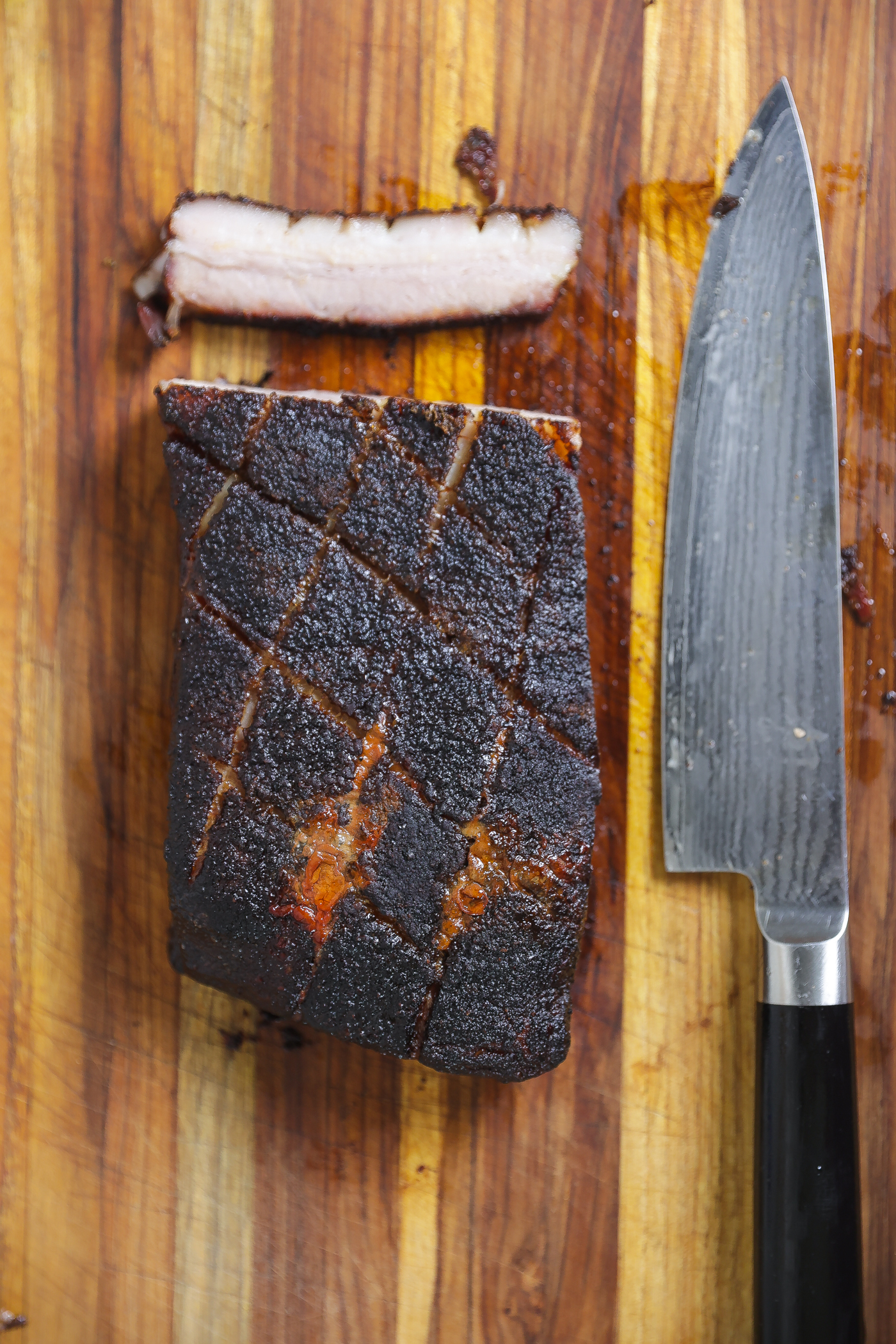 smoked pork belly on wooden cutting board