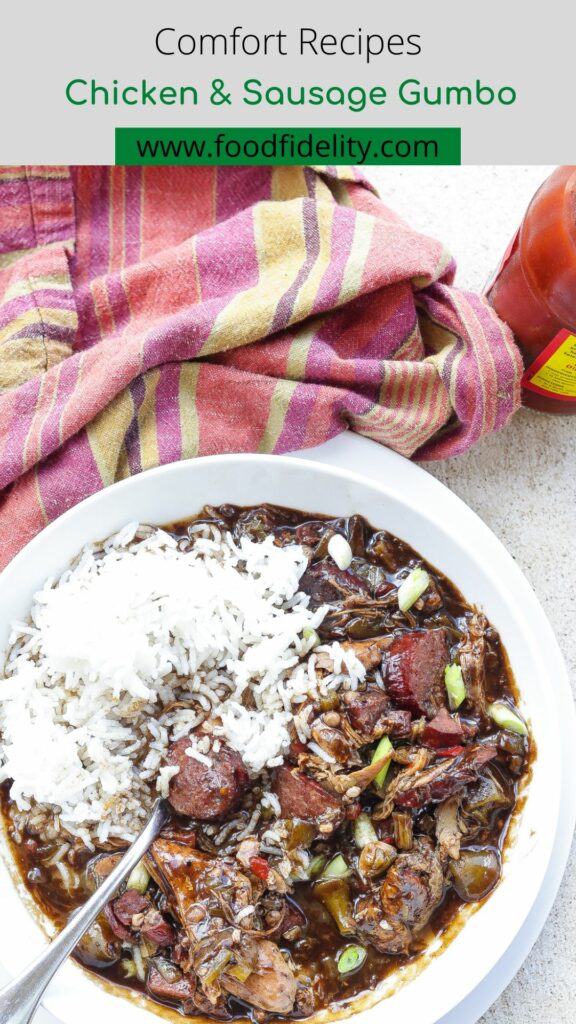 chicken and sausage gumbo with rice in white bowl.