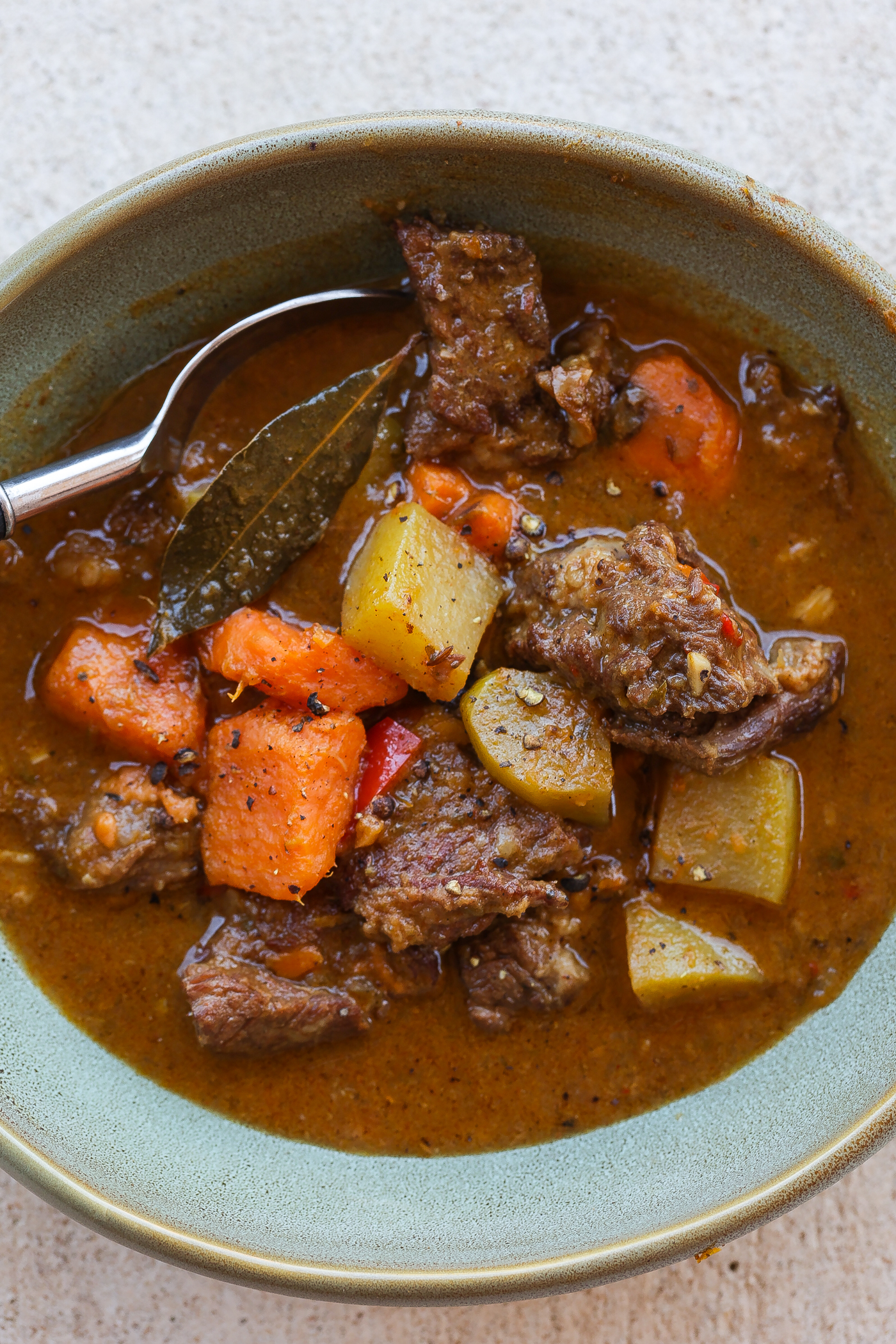 Hungarian goulash (beef stew) in a blue-green bowl
