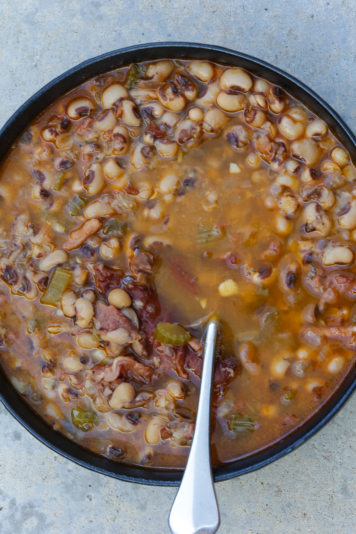 southern black eyed peas in black bowl with spoon