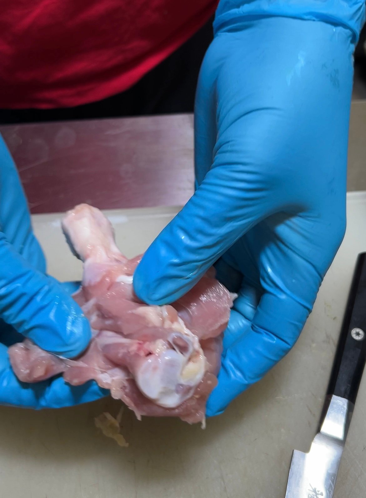 drumstick being butterflied cut with knife