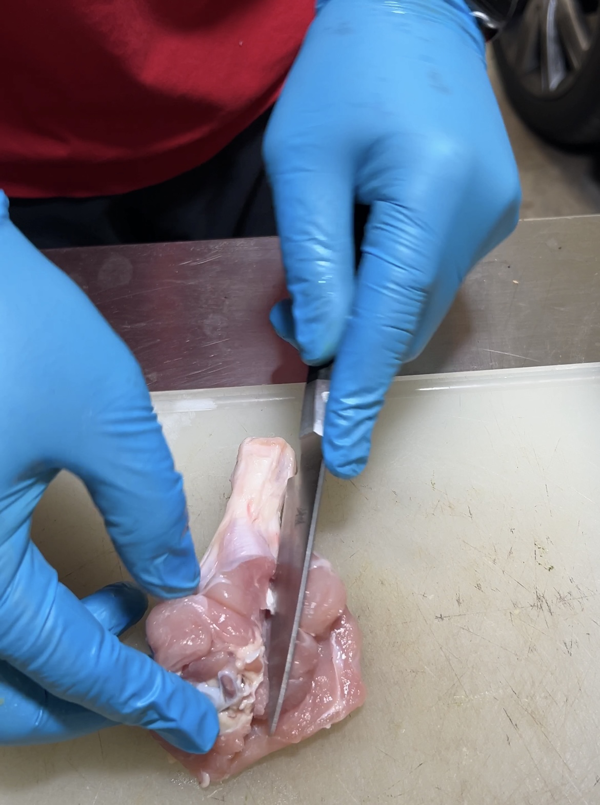 drumstick being butterflied cut with knife