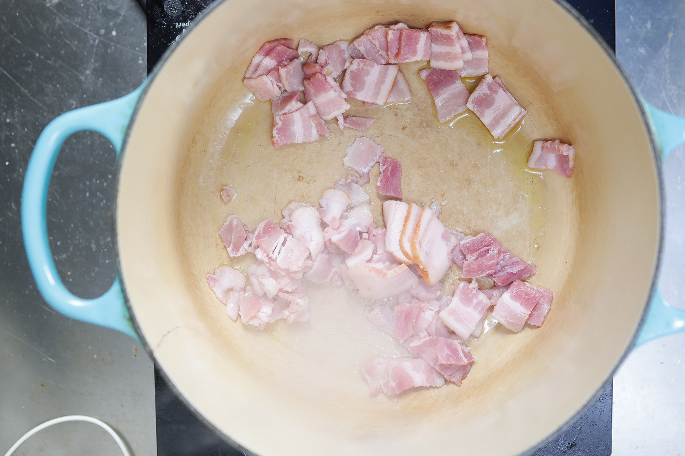 bacon frying in a pot